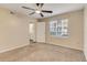 Bright bedroom with ceiling fan and access to laundry at 7240 Westpointe Blvd # 1115, Orlando, FL 32835