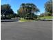 Landscaped entrance to Bermuda Dunes community with palm trees and paved roads at 7240 Westpointe Blvd # 1115, Orlando, FL 32835