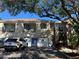 Charming condo exterior with private garages, balconies and mature shade trees at 7240 Westpointe Blvd # 1115, Orlando, FL 32835