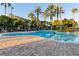 Resort-style pool with palm trees and lounge area at 7240 Westpointe Blvd # 1115, Orlando, FL 32835