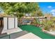 Landscaped backyard with shed and artificial turf at 743 Golden Sunshine Cir, Orlando, FL 32807