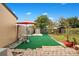 Landscaped backyard with patio, artificial turf, and shed at 743 Golden Sunshine Cir, Orlando, FL 32807