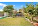 Large backyard with covered patio and lush landscaping at 743 Golden Sunshine Cir, Orlando, FL 32807