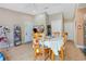 Dining area with wooden table and chairs, adjacent to entryway and kitchen at 743 Golden Sunshine Cir, Orlando, FL 32807