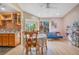 Dining area with wooden table and chairs, adjacent to kitchen and living room at 743 Golden Sunshine Cir, Orlando, FL 32807