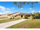 Two-unit home with a shared driveway, manicured lawn, and lush landscaping at 743 Golden Sunshine Cir, Orlando, FL 32807