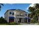 Two-story house with a blue roof, balcony, and palm trees at 749 S Atlantic S Ave, Ormond Beach, FL 32176