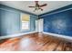 Simple bedroom with hardwood floors and blue accent wall at 750 E Pearl St, Bartow, FL 33830