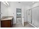 Main bathroom with walk-in shower and granite vanity at 7859 Summerlake Groves St, Winter Garden, FL 34787