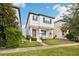 Two-story house with modern facade, front porch, and landscaped lawn at 7859 Summerlake Groves St, Winter Garden, FL 34787