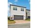 Modern two-story home with gray garage door at 7859 Summerlake Groves St, Winter Garden, FL 34787