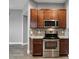 Modern kitchen with wood cabinets and granite countertops at 7859 Summerlake Groves St, Winter Garden, FL 34787