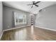 Living room with wood-look floors and large window at 7859 Summerlake Groves St, Winter Garden, FL 34787