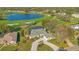 Beautiful aerial view of a home overlooking a peaceful lake and golf course, showcasing the property's serene setting at 8513 Bay Hill Blvd, Orlando, FL 32819