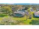 Aerial view of home with pool and golf course views at 8513 Bay Hill Blvd, Orlando, FL 32819