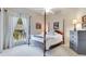 Bedroom with four-poster bed, neutral walls, and bright window views at 8513 Bay Hill Blvd, Orlando, FL 32819