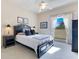 Comfortable bedroom with neutral colors, a ceiling fan, and natural light from the window at 8513 Bay Hill Blvd, Orlando, FL 32819