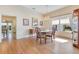 A dining room features hardwood floors, a decorative chandelier, and natural light from large windows at 8513 Bay Hill Blvd, Orlando, FL 32819