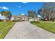 House exterior featuring a brick driveway and lush landscaping at 8513 Bay Hill Blvd, Orlando, FL 32819