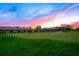 Clubhouse exterior at sunset with putting green in foreground at 8513 Bay Hill Blvd, Orlando, FL 32819