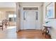 Welcoming foyer with hardwood floors, a decorative table, and a view into the adjacent dining area at 8513 Bay Hill Blvd, Orlando, FL 32819