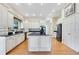 A well-lit kitchen includes custom white cabinets, granite countertops, stainless appliances, and a center island at 8513 Bay Hill Blvd, Orlando, FL 32819