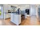 A well-lit kitchen includes custom white cabinets, granite countertops, stainless appliances, and a center island at 8513 Bay Hill Blvd, Orlando, FL 32819