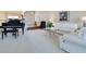 Elegant living room with plush white sofas, a grand piano, and neutral carpeting, creating a welcoming atmosphere at 8513 Bay Hill Blvd, Orlando, FL 32819