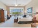 A spacious main bedroom features an attached sitting area with a view of a beautiful landscape at 8513 Bay Hill Blvd, Orlando, FL 32819