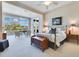 Spacious main bedroom featuring a desk area, sitting area, a large window, and natural light at 8513 Bay Hill Blvd, Orlando, FL 32819