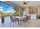 Covered patio featuring a dining table and seating area, with views of the pool and lush landscaping at 8513 Bay Hill Blvd, Orlando, FL 32819