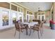 Outdoor patio featuring dining table, seating, and views through the windows and doors to the exterior at 8513 Bay Hill Blvd, Orlando, FL 32819