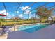 Inviting pool area with screened enclosure, offering picturesque golf course views at 8513 Bay Hill Blvd, Orlando, FL 32819