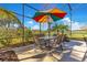 Enclosed pool deck features outdoor dining area with umbrella at 8513 Bay Hill Blvd, Orlando, FL 32819