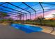 Enclosed pool with colorful sunset and view of the golf course at 8513 Bay Hill Blvd, Orlando, FL 32819