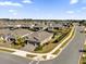 Aerial view of a house in a residential neighborhood with a well-manicured lawn at 943 Gracie Ridge St, Clermont, FL 34715