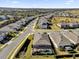 Aerial view of a house with a pool and surrounding neighborhood at 943 Gracie Ridge St, Clermont, FL 34715