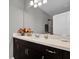 Bathroom with dark vanity, granite countertop, and mirror at 943 Gracie Ridge St, Clermont, FL 34715