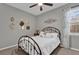 Bedroom with a metal bed frame and decorative wall art at 943 Gracie Ridge St, Clermont, FL 34715