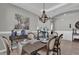 Beautifully set dining table with chandelier and decorative accents at 943 Gracie Ridge St, Clermont, FL 34715