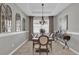 Formal dining room with chandelier, large artwork, and sideboard at 943 Gracie Ridge St, Clermont, FL 34715