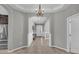 Bright and airy entryway with tile flooring and elegant chandelier at 943 Gracie Ridge St, Clermont, FL 34715