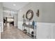 Bright and spacious entryway with tiled floors and decorative console table at 943 Gracie Ridge St, Clermont, FL 34715