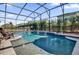 Inviting swimming pool with waterfall feature at 943 Gracie Ridge St, Clermont, FL 34715