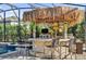 Custom tiki bar with seating and grill at 943 Gracie Ridge St, Clermont, FL 34715