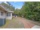 Brick path leads to a screened porch and lush greenery at 958 Dunraven Dr, Winter Park, FL 32792