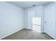 Bedroom featuring carpet flooring, a double door closet, and a separate door at 1147 Moyle Way, Mascotte, FL 34753