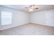 Cozy bedroom with carpet flooring and a large window for ample natural light at 1147 Moyle Way, Mascotte, FL 34753
