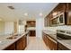 Bright kitchen with a large island, stainless steel appliances, and granite countertops at 1147 Moyle Way, Mascotte, FL 34753