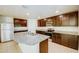 Kitchen featuring granite countertops, stainless steel appliances, and dark brown cabinets at 1147 Moyle Way, Mascotte, FL 34753